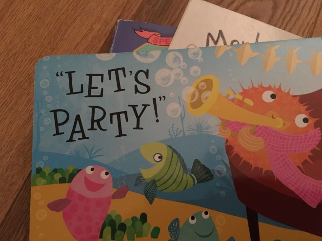 Photo of books with an illustration of fish and the words 