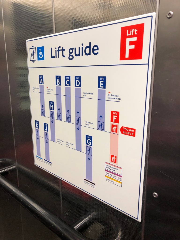 A sign showing the Lift Guide in a London Tube station with lifts marked A to F.