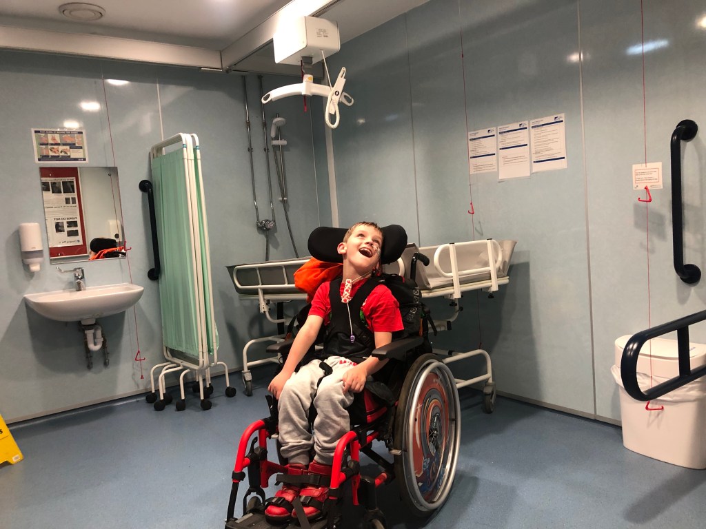 Quinns smiles in the Changing Place toilet in the education centre in Lochore Meadows Country Park.