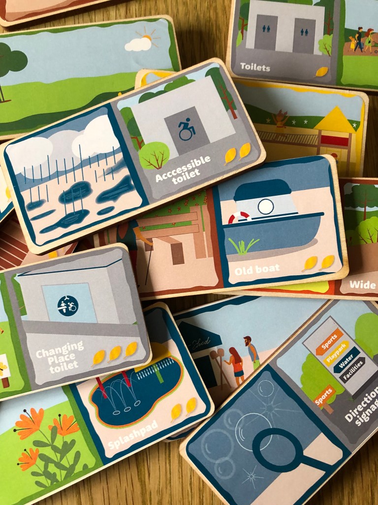 A random selection of illustrated domino tiles including a Changing Place toilet, Old Boat, Accessible Toilet and Direction Signage.