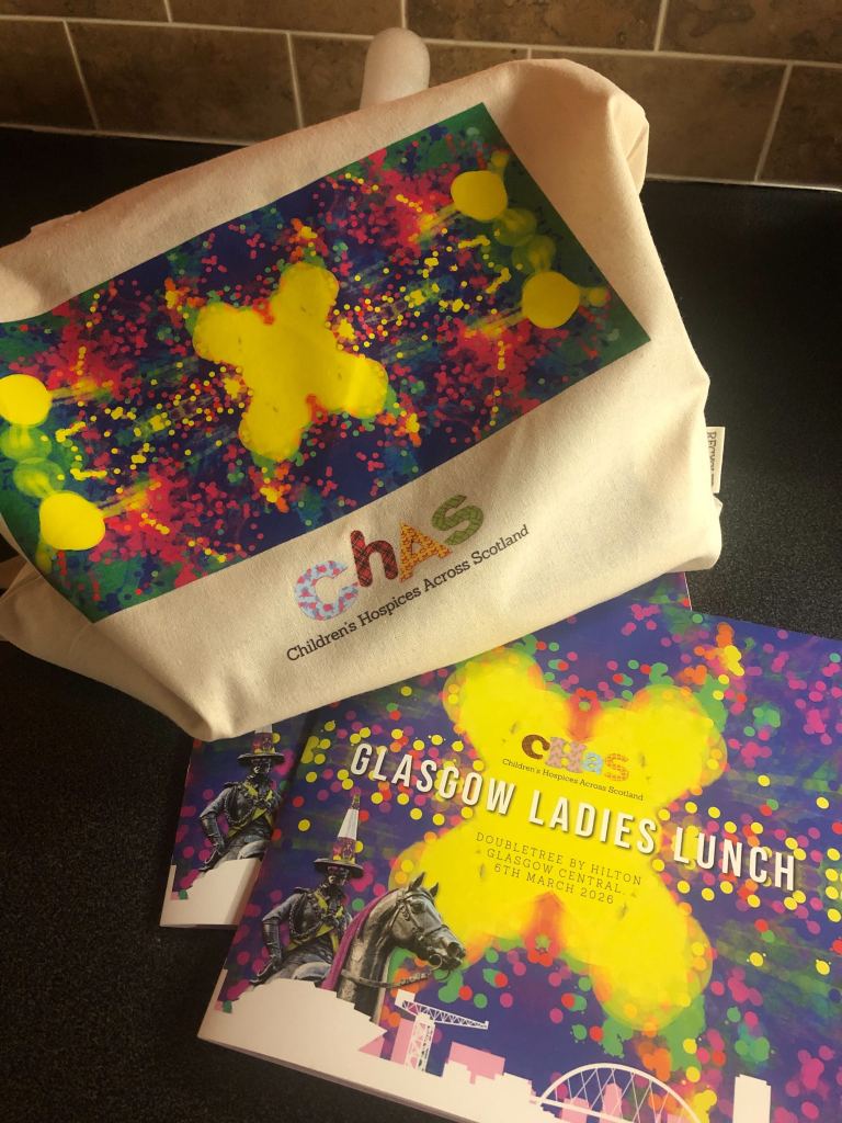CHAS Ladies Lunch tote bag with Quinns' artwork alongside two copies of the programme.