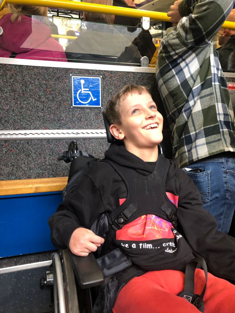 Quinns smiles as he sits waiting for the mountain railway train to start moving up Cairngorm.